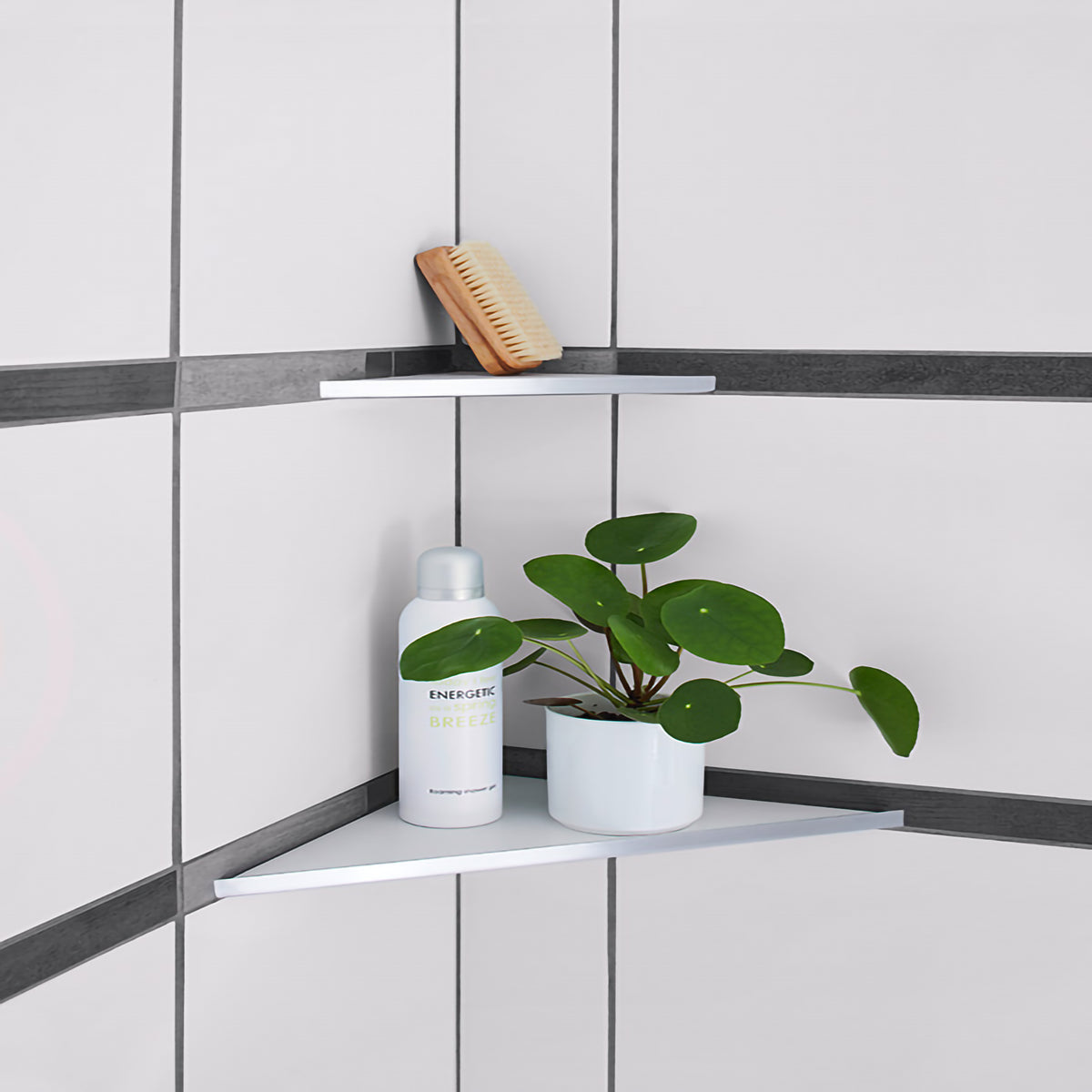 Lifestyle image of the triangular stainless steel shelf with white tile in the shower