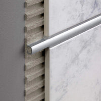 Decorative profile aluminium silver (matt) installed between light-coloured tiles