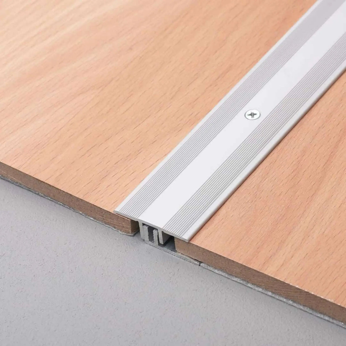 DURAL transition profile DUOFLOOR silver with visible screws installed between parquet flooring