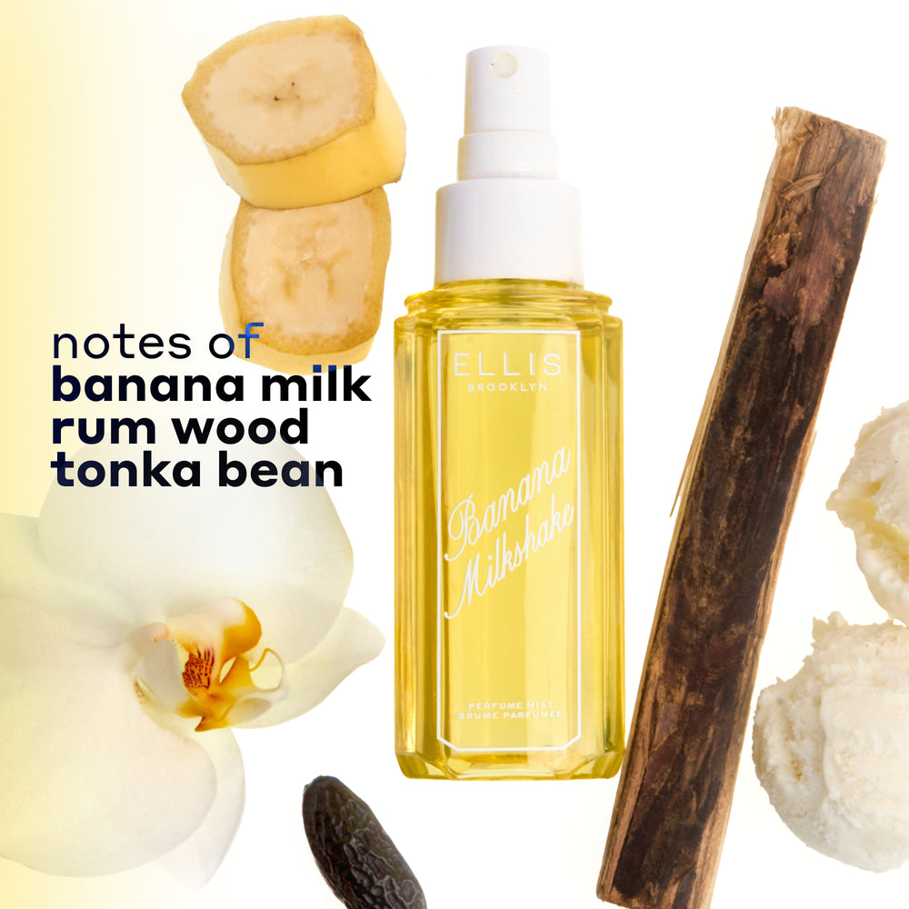 BANANA MILKSHAKE Perfume Mist 240ml without a cap surrounded by 2 slices of banana, a piece of rum wood, 2 scoops of vanilla ice cream, a tonka bean, and a flower on a white and yellow ombré background with black text that reads "notes of banana milk, rum wood, tonka bean" | english_image