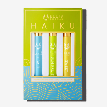Green, blue, and gold Haiku Fragrance Rollerball Trio Box showing Salt 10ml Fragrance Rollerball, Sun Fruit 10ml Fragrance Rollerball, and Sweet 10ml Fragrance Rollerball, on white background. | english_image