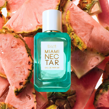 Miami Nectar 50ml Eau De Parfum on slices of pink pineapples, on white background.