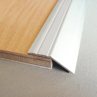 Lifestyle image ramp profile aluminium silver with ribbed surface creating transition to parquet
