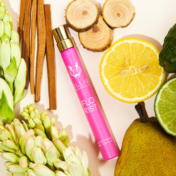 Florist 10ml Eau De Parfum Travel Spray on pale pink background with lemon, lime, sandal wood, pear, flowers, and cedar wood.